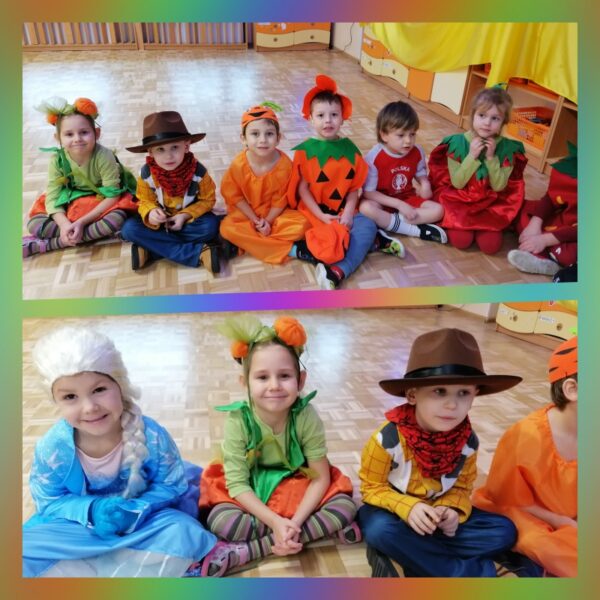 Dzieci siedzą w szeregu na podłodze i prezentują swoje stroje: Elza, Chudy, dynia, marchewka, truskawka, piłkarz.